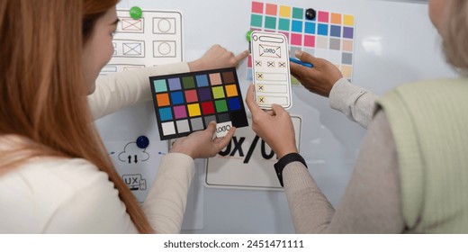 ux developer and ui designer presenting mobile app interface design on whiteboard in meeting at office. Creative digital development mobile app agency. digital transformation