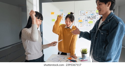 Ux developer and Ui designer successful creative in smart casual wear discussing phone application design celebrate giving five after dealing feeling happy in office - Shutterstock ID 2395367117