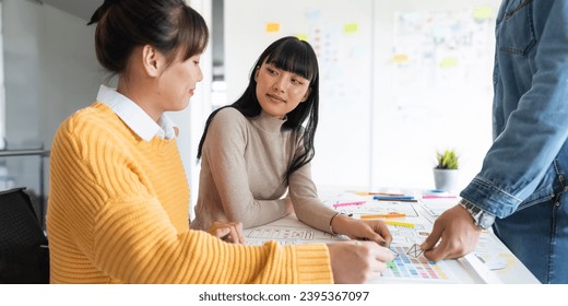 Ux developer and ui designer use augmented reality brainstorming about mobile app interface wireframe design on desk at modern office. creative digital development agency - Shutterstock ID 2395367097