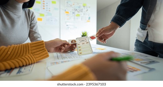 Ux developer and ui designer use augmented reality brainstorming about mobile app interface wireframe design on desk at modern office. creative digital development agency - Shutterstock ID 2395367103