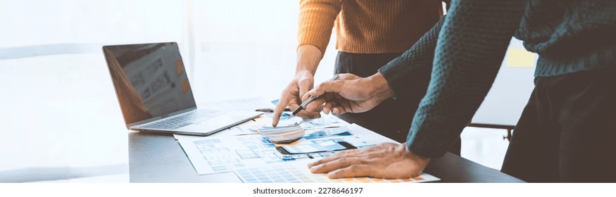 ux developers and ui designers, data researchers brainstorm on  tabletop mobile app interface wireframe design with client summary color codes the modern office Creative Digital Development Agency.