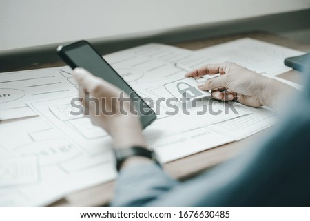 ux graphic designer discussing to sketch smartphone application for web mobile phone, application concept