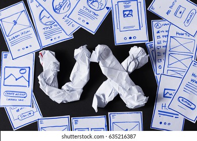 UX Letters Made Of Crumpled Paper, Designer Desk With Mobile Application Screen Sketches. User Experience Design Creative Process