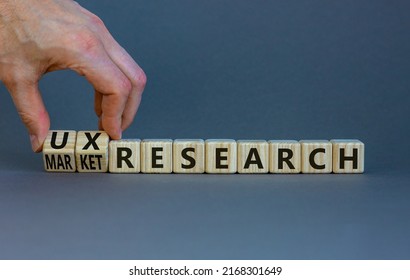 UX Or Market Research Symbol. Businessman Turns Wooden Cubes And Changes Words Market Research To UX Research. Beautiful Grey Background. Business, UX Or Market Research Concept. Copy Space.