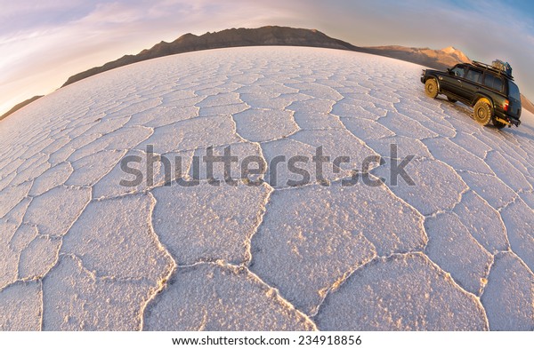 UYUNI - NOVEMBER \
12:Tourists move on salt   desert Uyuni on off-road car  on\
November  12, 2014 in Uyuni, Bolivia. Desert Uyuni is one of the\
greatest salt deserts in the\
world