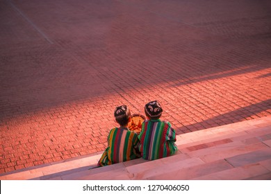 Uzbek children in Registan Square, in traditional clothes with doira. Samarkand, Uzbekistan