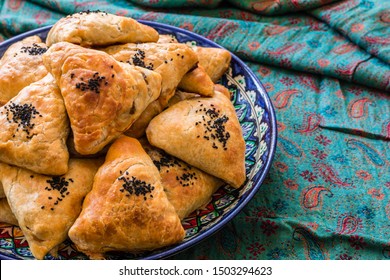 Uzbek Samsa or Sambousak in national plate. Samsa or Sambousak an oriental meal to be stuffed with minced meat, cheese or vegetables. The national dish of Uzbekistan and Central Asia. - Shutterstock ID 1503294623