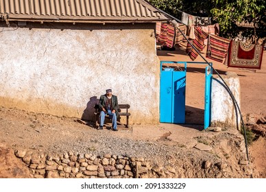 Uzbekistan, village of Katta Langar, an old man sits in front of his house.The  15th of October 2021