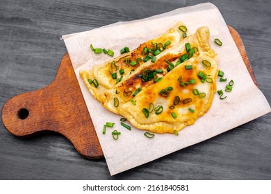 Uzbek,Tatar cuisine,cheburek with beef,pork meat,onions,greens on wooden board.Fresh baked homemade Cornish pasties,fried stews pie wrapped in shortcrust pastry.Traditional Turkish mongolian dish. - Shutterstock ID 2161840581