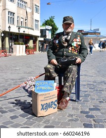 UZHGOROD,UKRAINE -MAY 09, 2017: War veteran begging money for surgery of his wife in Uzhgorod, Ukraine.