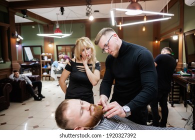 Uzhhorod, Ukraine. 10.20.2020 Barber training and master class. Possession of all the skills of trimming a man's head and beard. Bearded man sitting in a chair with a haircut. Model men's haircut in a