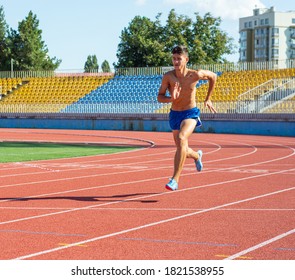 UZHHOROD, UKRAINE - SEPTEMBER 5, 2020: Male Teen Athlete Training On A Running Track On A Stadium. Male Runner Training On A Running Track In Uzhhorod, Ukraine