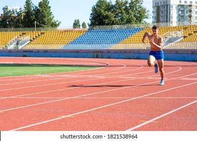 UZHHOROD, UKRAINE - SEPTEMBER 5, 2020: Male Teen Athlete Training On A Running Track On A Stadium. Male Runner Training On A Running Track In Uzhhorod, Ukraine