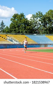 UZHHOROD, UKRAINE - SEPTEMBER 5, 2020: Male Teen Athlete Training On A Running Track On A Stadium. Male Runner Training On A Running Track In Uzhhorod, Ukraine