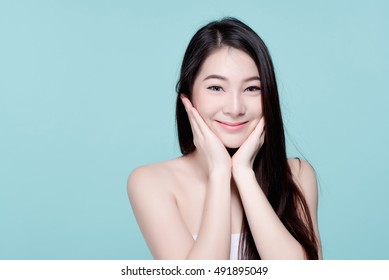 V Shape Face of Asian woman smiling and touching her face. Skincare and Cosmetology concept. blue background.