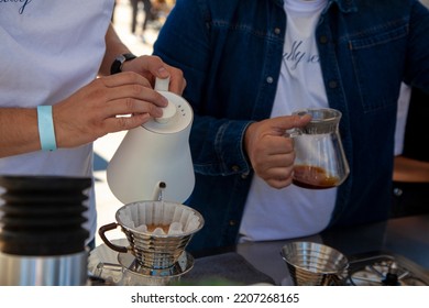 V60 The Method Of Brewing Coffee, The Man With The Wristband Brews Coffee.