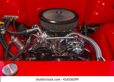 V-8 engine in a classic hot rod with chrome Fittings.