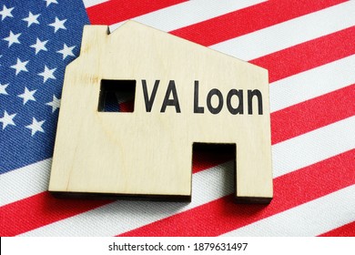 VA loan sign on the wooden home and American flag.