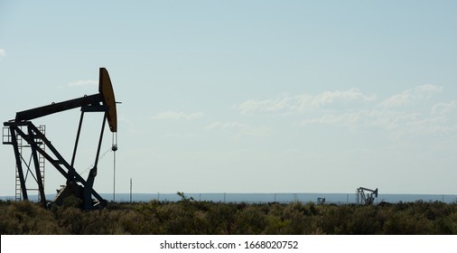 Vaca Muerta Field. Oil Pump Jack Pumping Crude Out Of The Ground In Neuquen, Argentina