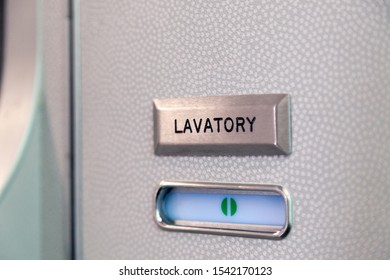 Vacant Green Sign, Vacant Symbol On An Airplane Lavatory Door. Raised, Brushed Metal Lavatory Sign, Recessed Plastic Vacant Sign. Toilet Room, Wc, Water Closet On Airplane Board