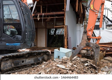 Vacant homes are a serious social problem. So there is a movement to demolish the vacant house.To demolish an empty house with heavy equipment. - Shutterstock ID 1464464483
