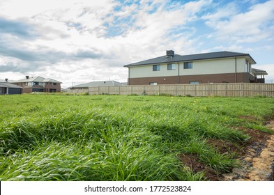 Vacant land next to some residential suburban houses. Concept of real estate development, land for sale and a new suburb, Tarneit, Melbourne, VIC Australia.