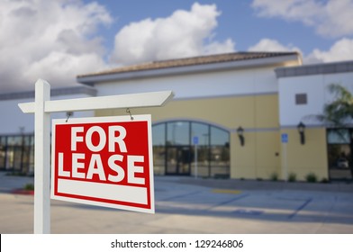 Vacant Retail Building With For Lease Real Estate Sign In Front.