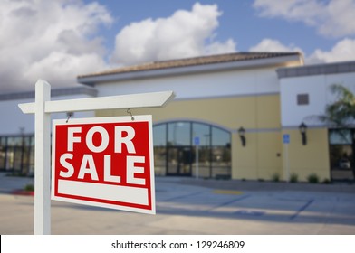 Vacant Retail Building With For Sale Real Estate Sign In Front.