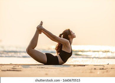 Vacation of Asian woman relaxing in yoga bow or dhanurasana pose on sand and beach with sunset sea in Thailand Tropical island,Feel comfortable and relax in holiday - Powered by Shutterstock