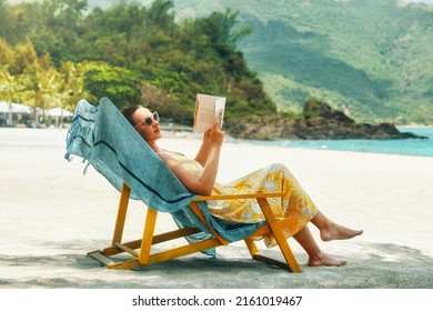 Vacation Beach Summer Holiday Concept. Woman reading book at beach resort during summer vacation. - Shutterstock ID 2161019467