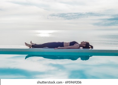 Vacation of Beautiful Attractive Asian woman relaxing in yoga Savasana pose on the pool above the beach with beautiful sea in Tropical island,Feeling comfortable and relax in holiday,Vacations Concept - Powered by Shutterstock