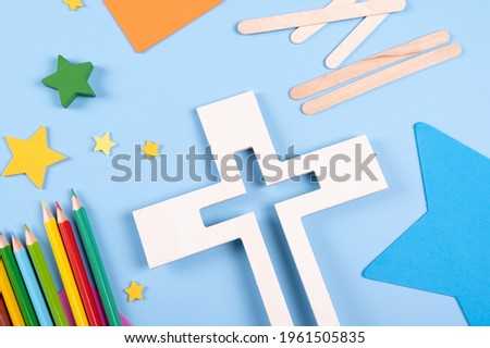 Vacation Bible School craft supply with wooden cross. Christian concept. Copy space text. Selective focus.