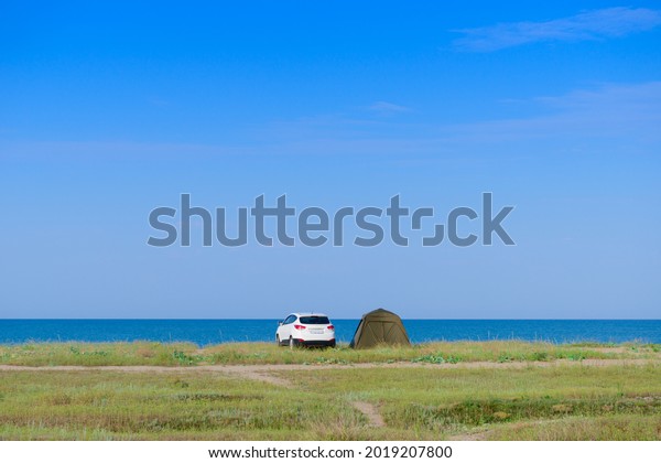 Vacation by the sea with\
a car and a tent