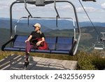 vacation in Carpathian mountains. woman on the lift in the mountains in summer. Ukrainian ski lift transportation.