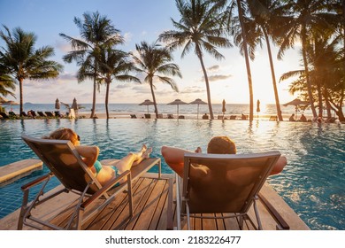 vacation, couple on the beach near swimming pool, luxury travel - Powered by Shutterstock