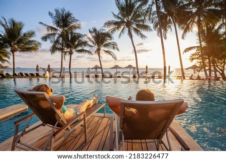 vacation, couple on the beach near swimming pool, luxury travel