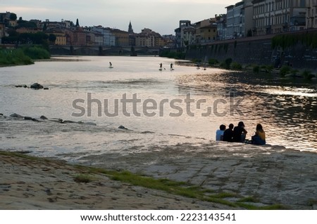 Vacation in Florence on the Arno River. People at niki tourism. Evening rest with sunset view.