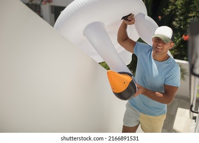 Vacation Happy Man With Funny Inflatable White Swan Pool Float. Summer Vacation