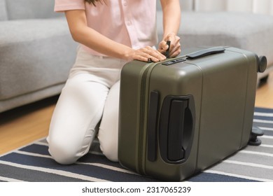 Vacation, holiday travel, traveler asian young woman, girl hand to close bag the zipper after packing, preparing stuff into luggage or baggage case for journey trip, preparation for journey voyage. - Shutterstock ID 2317065239