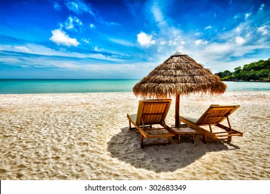 Vacation holidays background wallpaper - two beach lounge chairs under tent on beach. Sihanoukville, Cambodia - Shutterstock ID 302683349