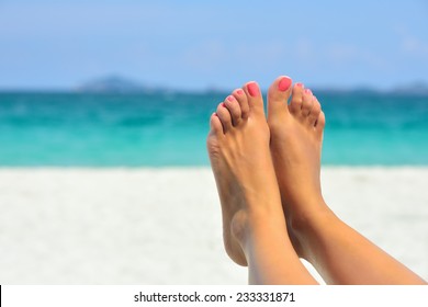 Vacation Holidays. Woman Feet Closeup Of Girl Relaxing On Beach On Sunbed Enjoying Sun On Sunny Summer Day.