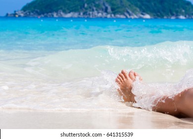 Vacation holidays. Woman feet closeup of girl relaxing on beach on sunbed enjoying sun on sunny summer day. - Powered by Shutterstock