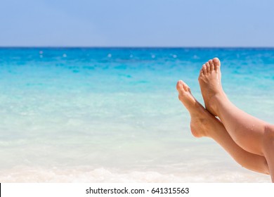 Vacation Holidays. Woman Feet Closeup Of Girl Relaxing On Beach On Sunbed Enjoying Sun On Sunny Summer Day.