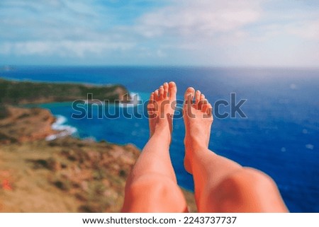Vacation holidays. Woman feet closeup of girl relaxing and enjoying the view of amazing landscape