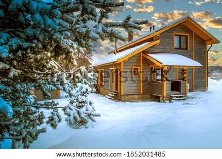 Vacation home. The cottage is covered in snow. Snowdrifts near the cottage. House away from the city. Concept - Christmas holiday away from the city. Northern nature. Wooden cottage on a winter day