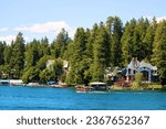 Vacation Homes with private docks on an alpine lake surrounded by pine trees taken at the resort mountain town of Lake Arrowhead, CA in the San Bernardino Mountains