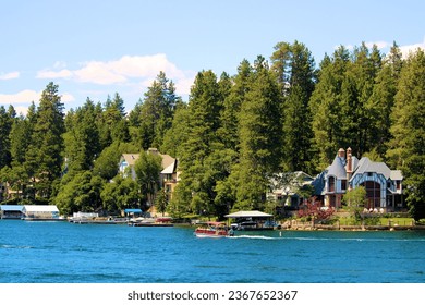 Vacation Homes with private docks on an alpine lake surrounded by pine trees taken at the resort mountain town of Lake Arrowhead, CA in the San Bernardino Mountains