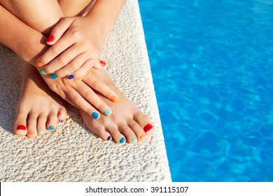 Vacation idea. Woman feet closeup. Beautiful pedicure. Girl relaxing beside swimming pool enjoying sun on sunny summer day.