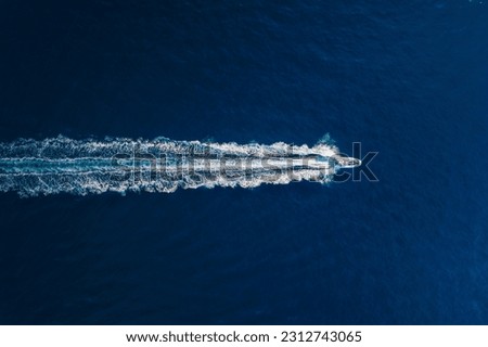 Vacation and leisure. Aerial view on fast boat on blue Mediterranean sea at sunny day. Fast ship on the sea surface. Seascape from the drone. Seascape from air. TSeascape with motorboat.