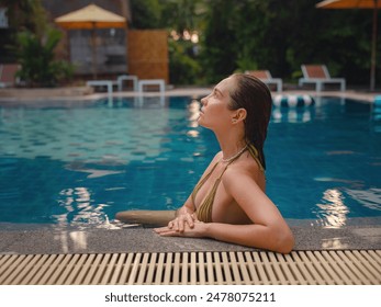 Vacation lifestyle scene of young woman sitting in swimming pool in morning time. Weekend and holiday lifestyle concept. - Powered by Shutterstock